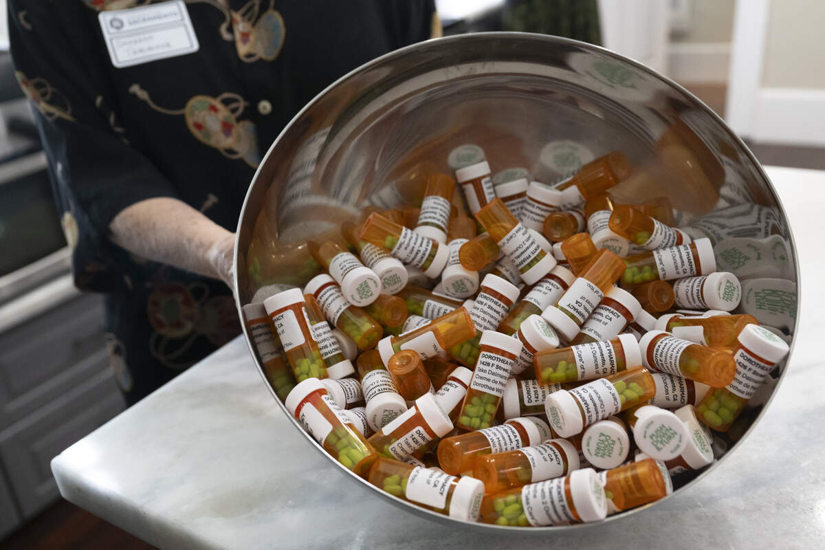 A Preservation Sacramento docent shows fake pill bottles filled with Tic Tacs at the former home of serial killer Dorothea Puente, now known as The Innocent House, during Preservation Sacramento’s annual historic home tour in Sacramento on Sunday. Puente, who operated the home as a boarding house and murdered her lodgers, was known to have drugged her victims.